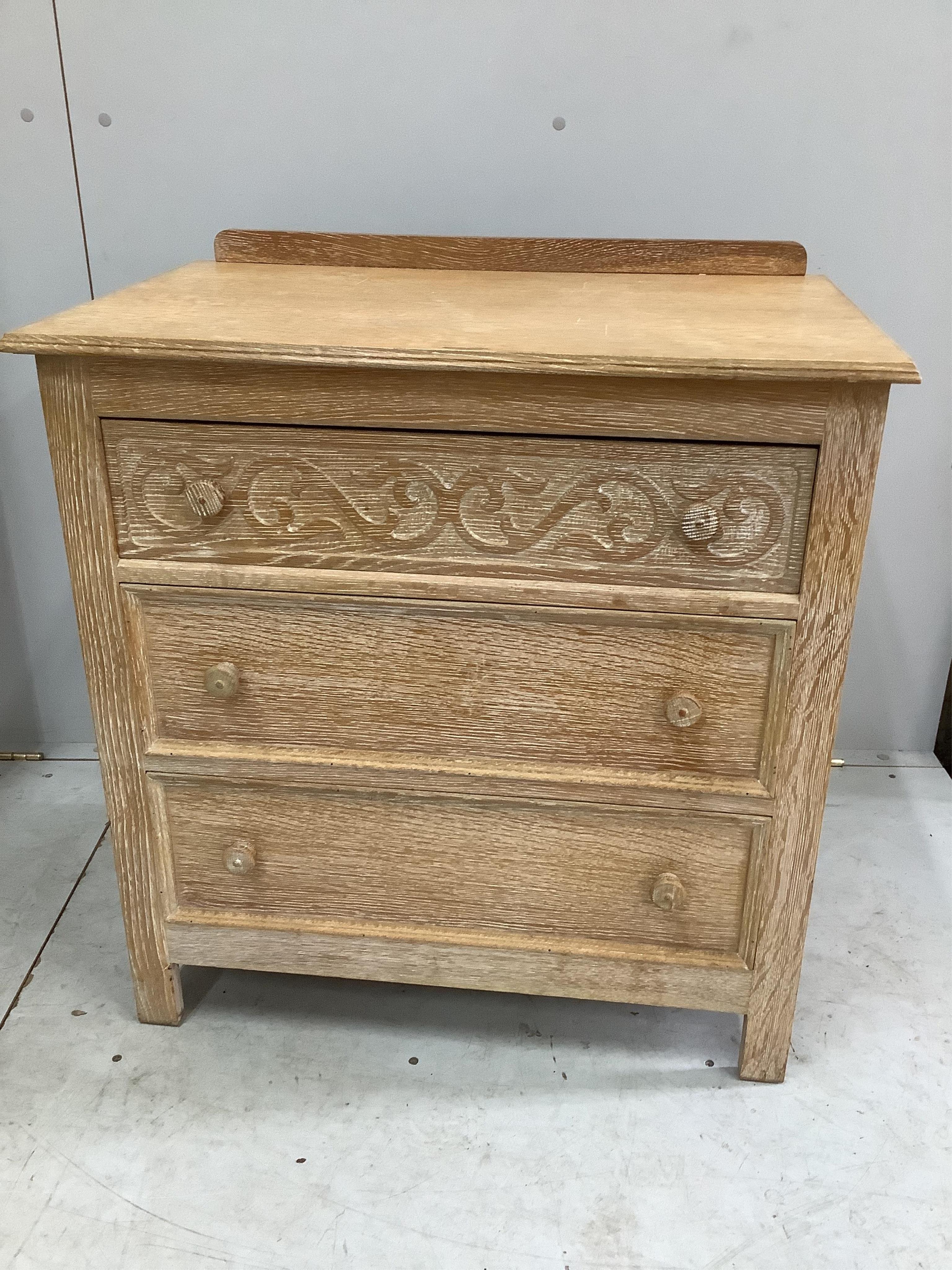 A limed oak four piece bedroom suite, comprising wardrobe, three drawer chest and a pair of single headboards. Condition - good